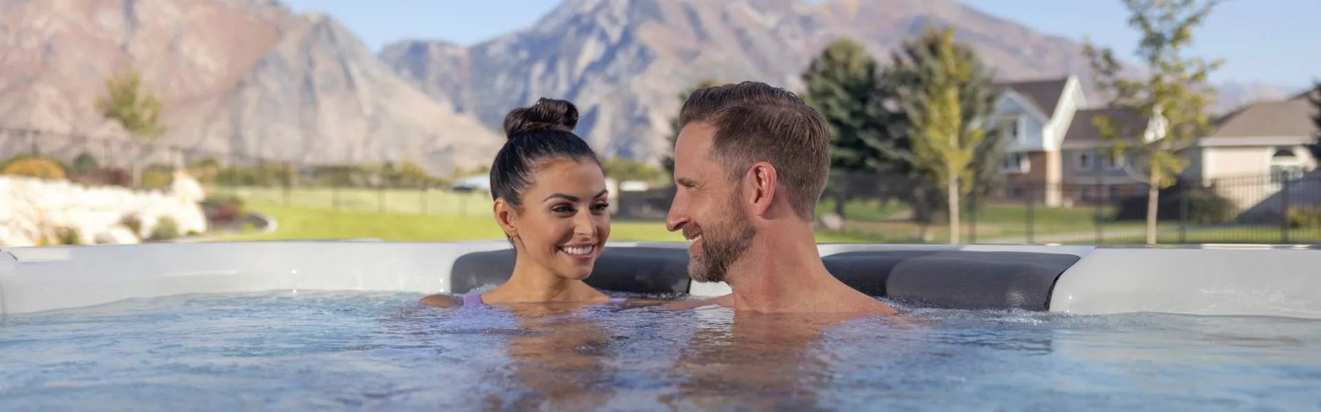 Couple happily relaxing in their Bullfrog Spas hot tub