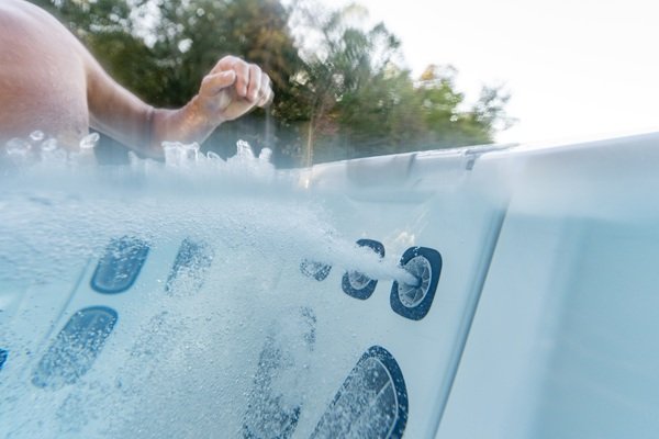 hot tub jets turned on and blasting water.