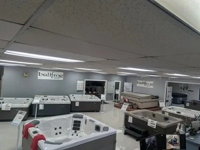 Abundant Life Stoves & Spas showroom floor in Chichester showing all their hot tub inventory from Bullfrog Spas.