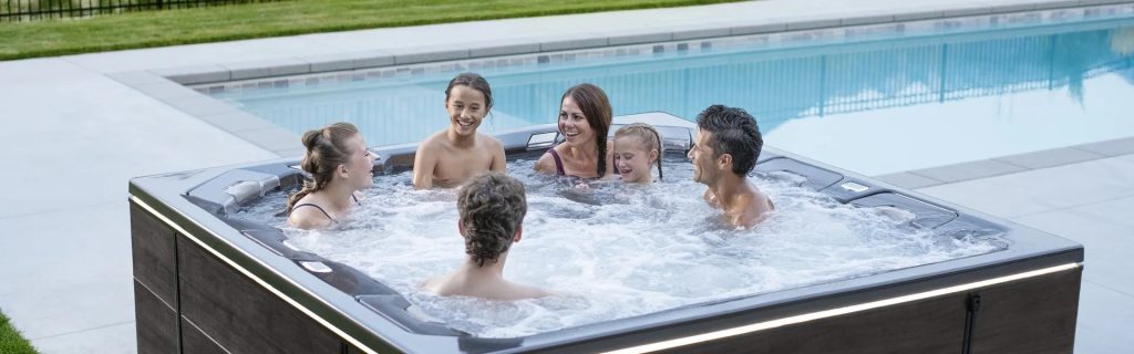 Family enjoying a Sunday Hot Tub retreat outdoors. 