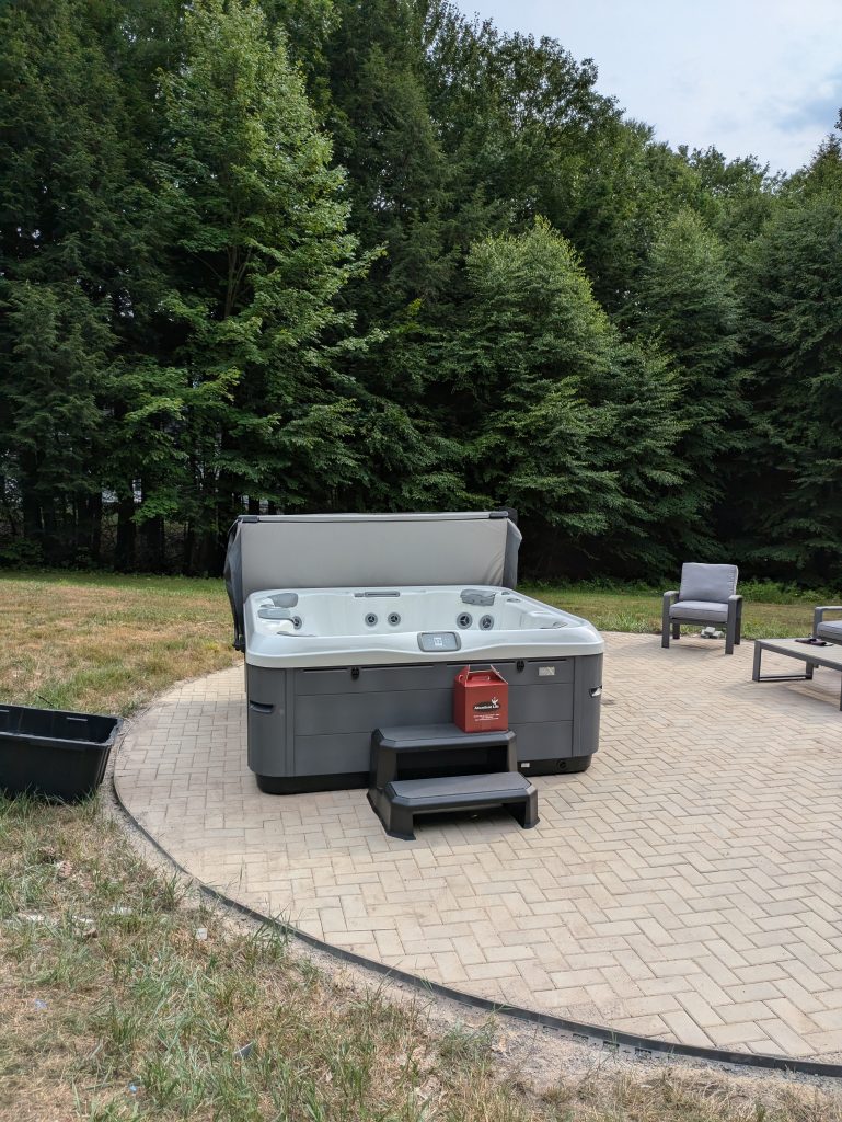 Serene Hot Tub Installation Surrounded by Nature 5